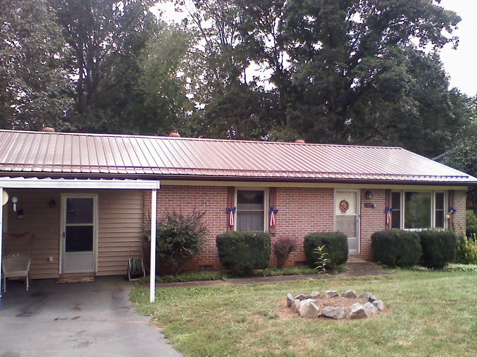 Bronze metal roof and carport on a brick ranch home — Roof Repair work by our crew in Davidsonville